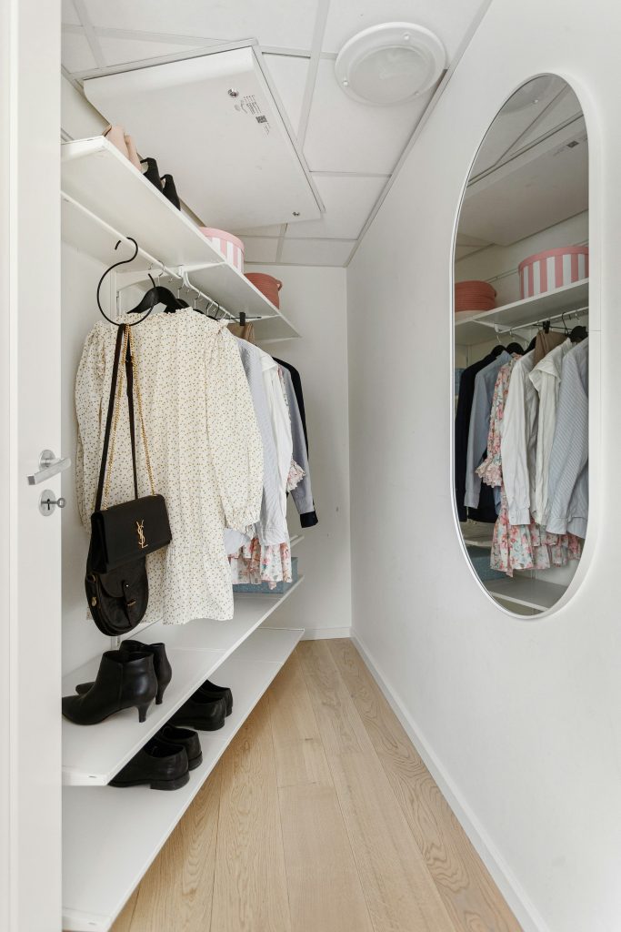 Neatly organized closet with matching hangers and folded clothes for a closet cleanout