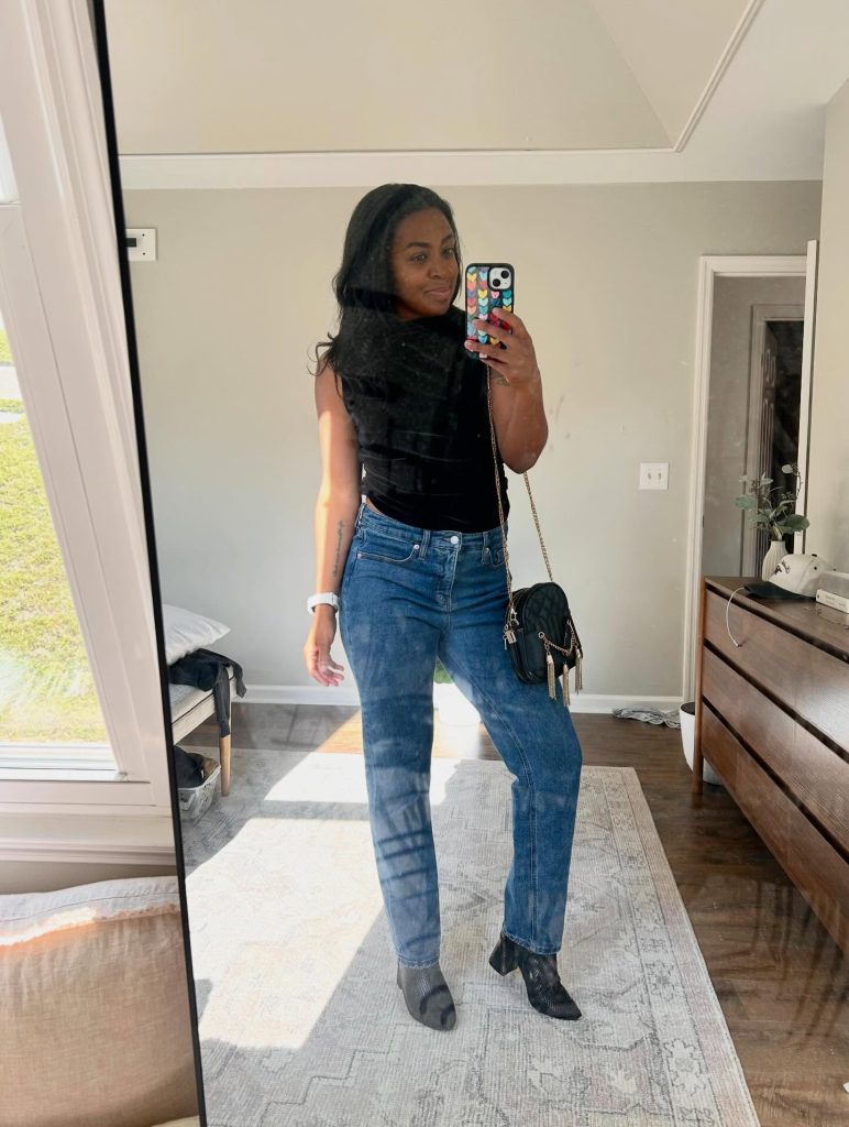 how to have a glow up at any age - woman in mirror with black shirt and jeans